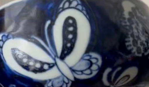 Butterfly decoration, cropped exterior detail of the actual cup